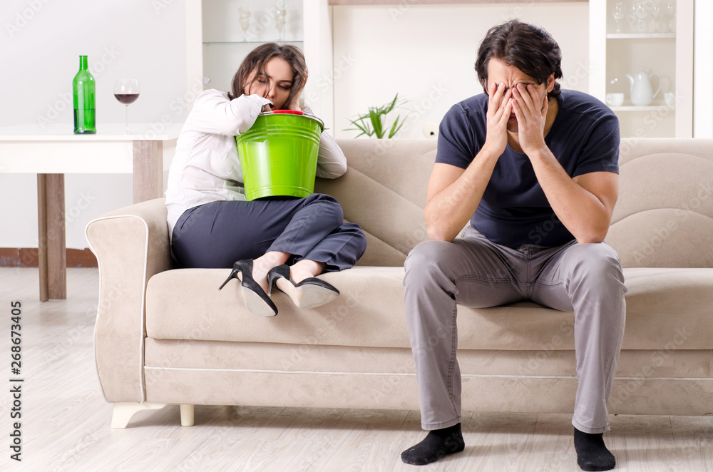 Fototapeta premium Young wife suffering from sick stomach and vomiting