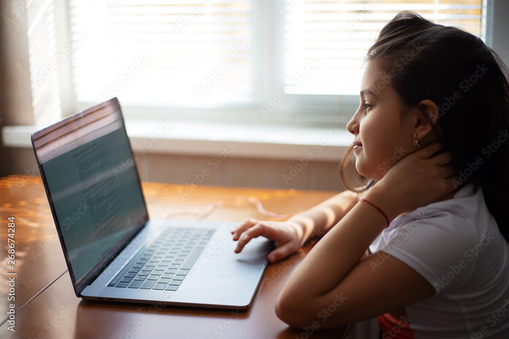 Modern children girl using laptop Modern children girl using laptop