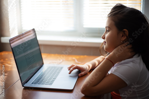 Modern children girl using laptop