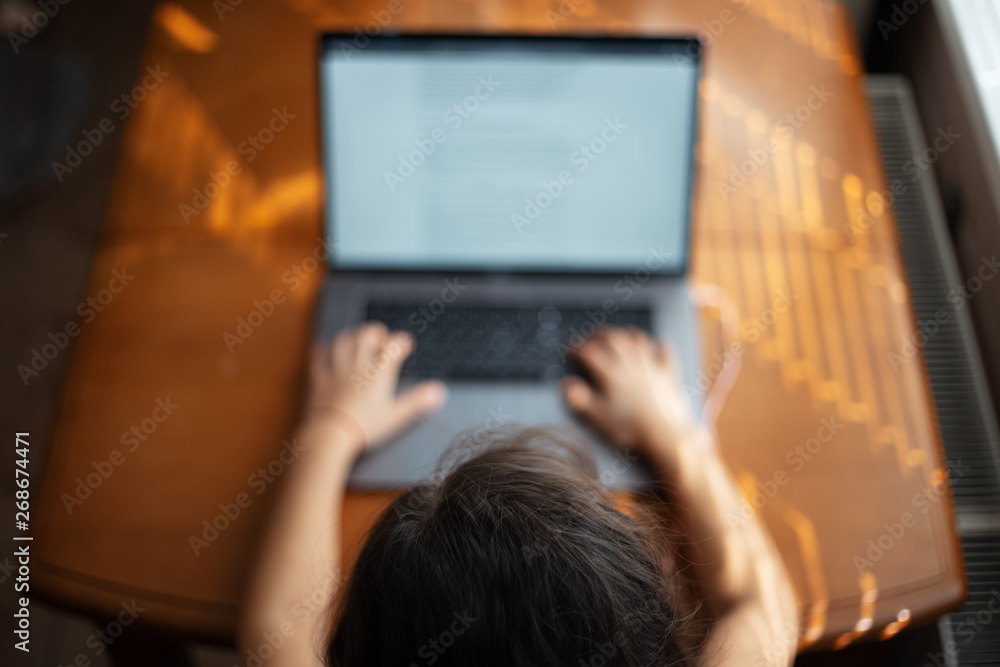 Children hands typing on keyboard of laptop Children hands typing on keyboard of laptop
