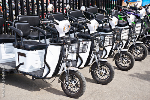 White electric scooters for rent in parking