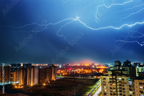 Multiple lighting bolts thunder during a storm with a dramatic blue sky in noida, delhi India - Image
