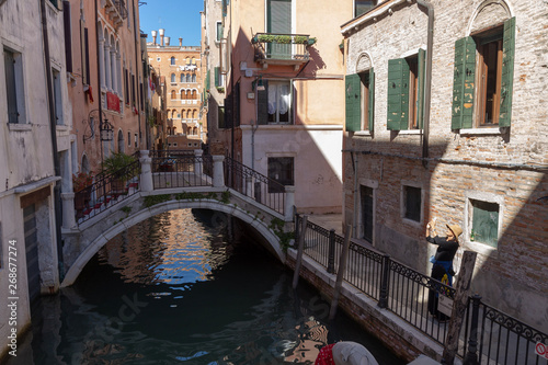 Footpath Bridge in a narrow Canal and the typical Venetian architecture. Venice, Italy