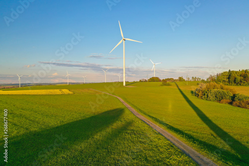 Wind turbines during sunset taken from the drone