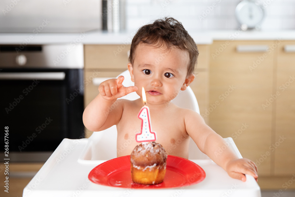 Baby trying to touch candle flame on first birthday Stock Photo Adobe Stock