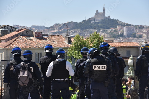 Helmeted police officers photographed from behind during a protest