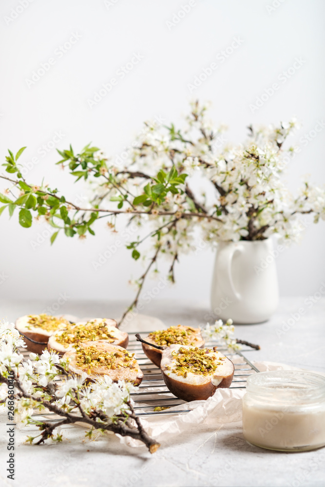 Baked pears with mascarpone and pistachios and blossoming apple branches