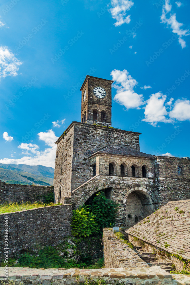 Clock tower in Historical UNESCO protected town of Gjirocaster with a castle on the top of the hill, Southern Albania