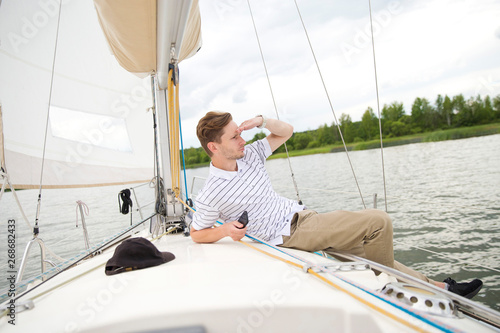 Handsome young man on yacht. © Object Studio