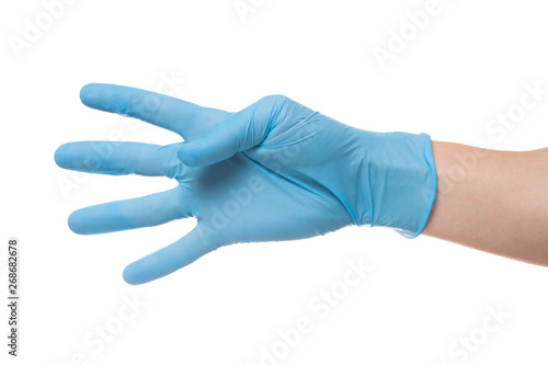 Right hand wearing latex surgical glove with gesture number four on wite background.