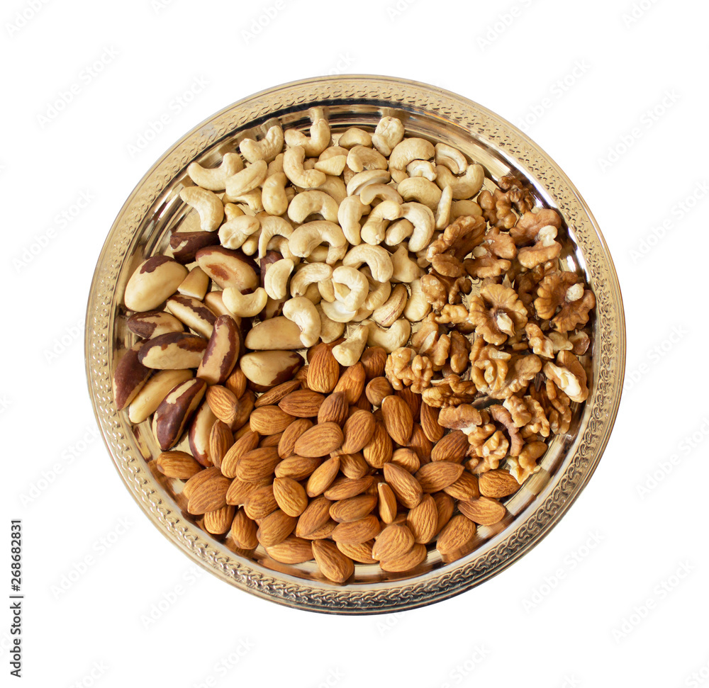 Insulated silver tray with the peeled nuts on a white background. Walnuts, cashews, Brazil nuts, almonds. Healthy, wholesome food Insulated silver tray with the peeled nuts on a white background. Walnuts, cashews, Brazil nuts, almonds. Healthy, wholesome food