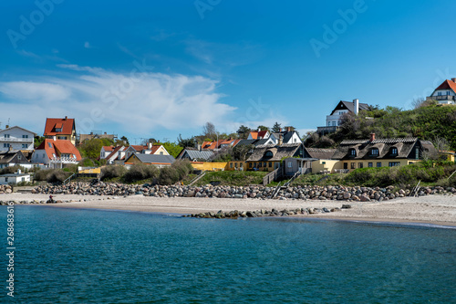 Small town houses on Tisvildeleje beach in Denmark on a sunny day photo