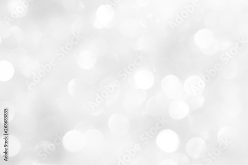 A brilliant white background with circles and ovals. Template for a holiday card with bright and sparkling lights.