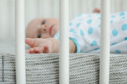 Cute little baby lying in crib, closeup