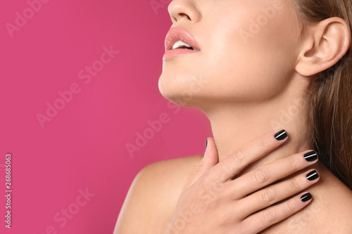 Beautiful woman with stylish nail polish on color background  closeup. Space for text