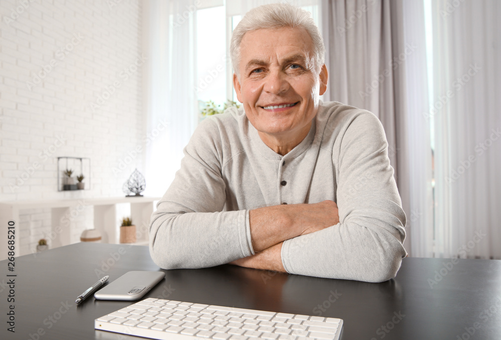 Mature man using video chat at home, view from web camera Mature man using video chat at home, view from web camera