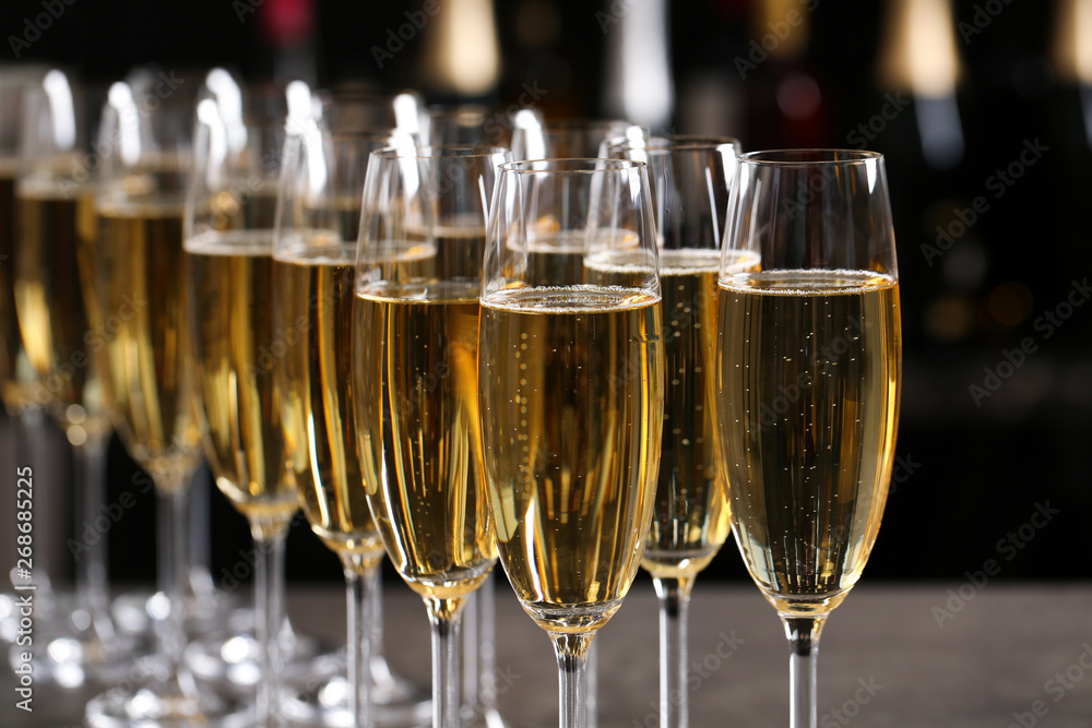 Many glasses of champagne on blurred background, closeup Many glasses of champagne on blurred background, closeup