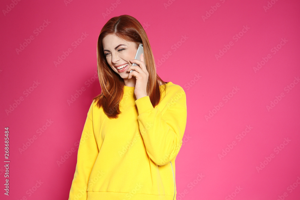 Portrait of beautiful woman talking on phone against color background. Space for text Portrait of beautiful woman talking on phone against color background. Space for text