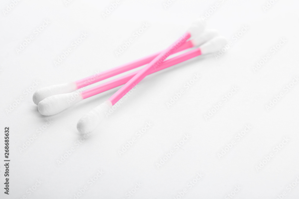 Pink plastic cotton swabs on white background Pink plastic cotton swabs on white background