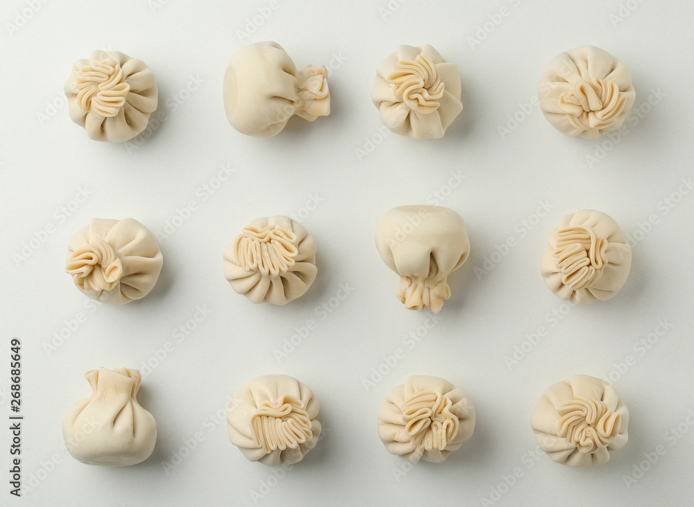 Composition with raw dumplings on white background, top view Composition with raw dumplings on white background, top view