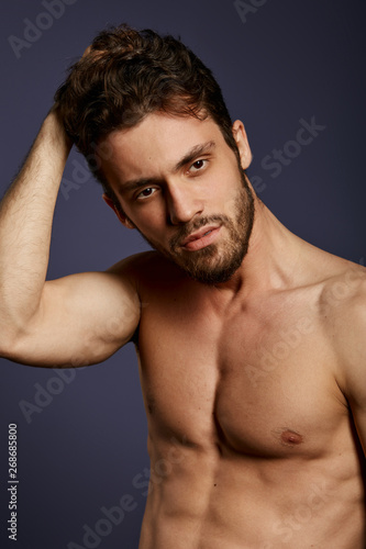 serious awesome bearded man scratching his head expresses pensive emotion, feeling, thoughtful shirtless man with a hand on his head posing to the camera. guy sloves problems. close up portrait photo