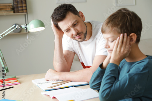 Stampa su tela Dad struggling to help his son with school assignment at home