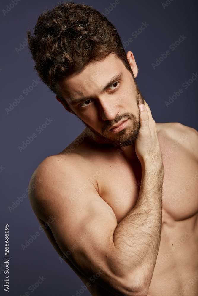 thoughtful handsome man holding his beard, to shave or not to shave, guy doesn't like his beard, appearance concept. skin care thoughtful handsome man holding his beard, to shave or not to shave, guy doesn't like his beard, appearance concept. skin care