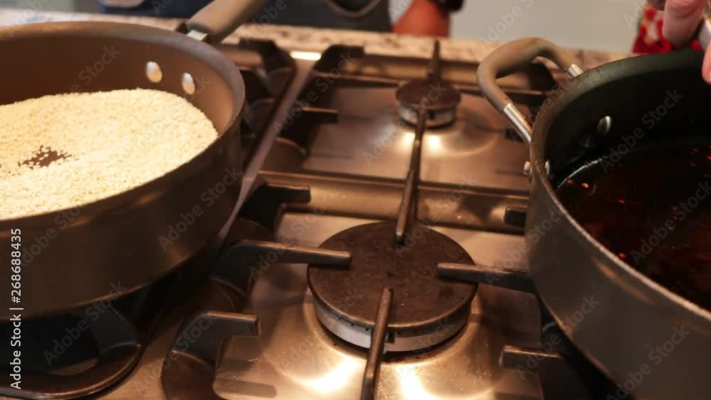 Top view. Sesame Seeds in the pot. Preparing Mole from Puebla, Mexico. North America. Cooking Traditional recipe Top view. Sesame Seeds in the pot. Preparing Mole from Puebla, Mexico. North America. Cooking Traditional recipe