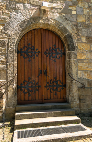 old Wooden door with iron fittings on a historical building / church in Castle Cappenberg/ Germany