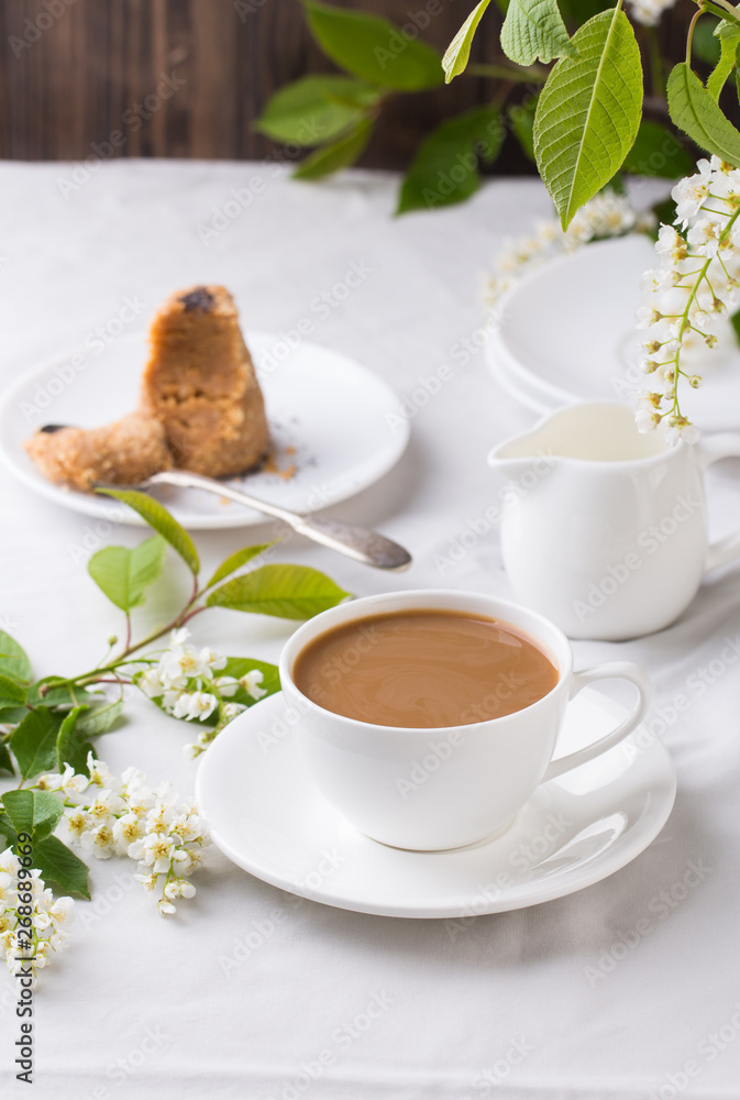Creamy Coffee in white mug with bird-cherry tree blossom Creamy Coffee in white mug with bird-cherry tree blossom