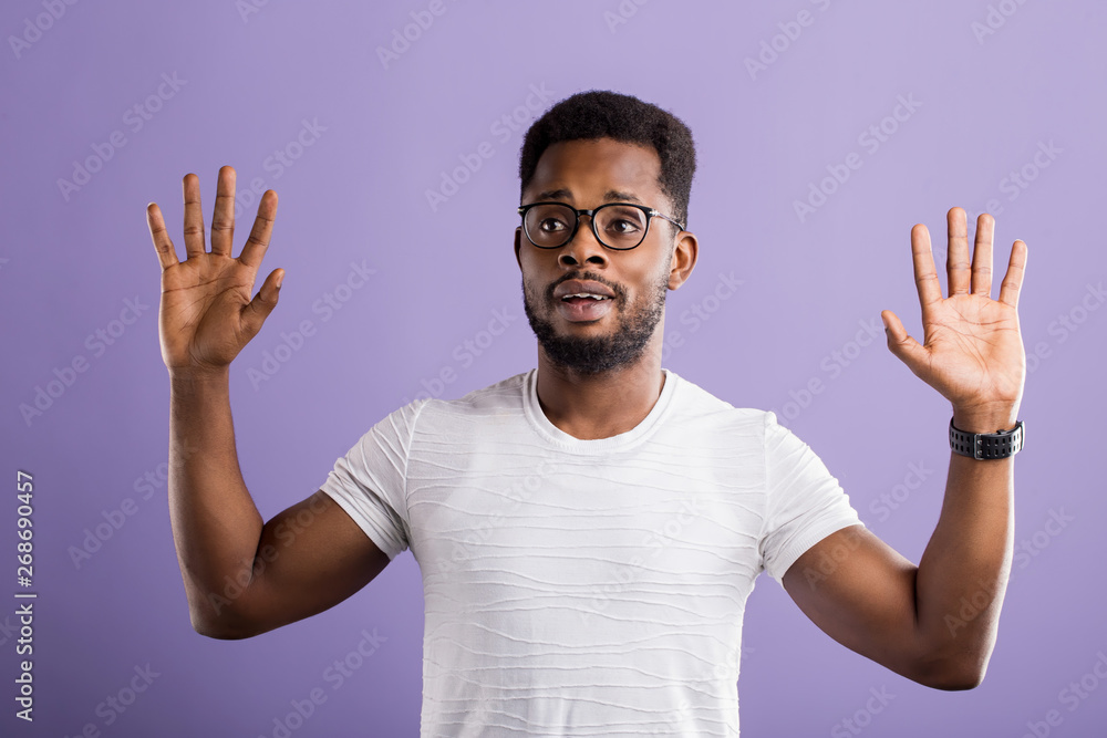 Dark skinned man isolated over purple background Dark skinned man isolated over purple background