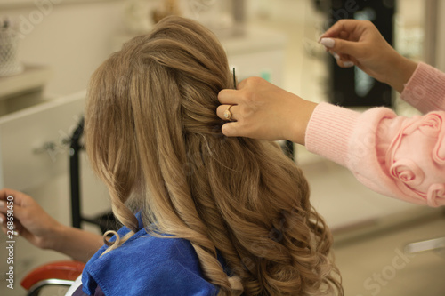 young girl beautifully styled hair in a beauty salon