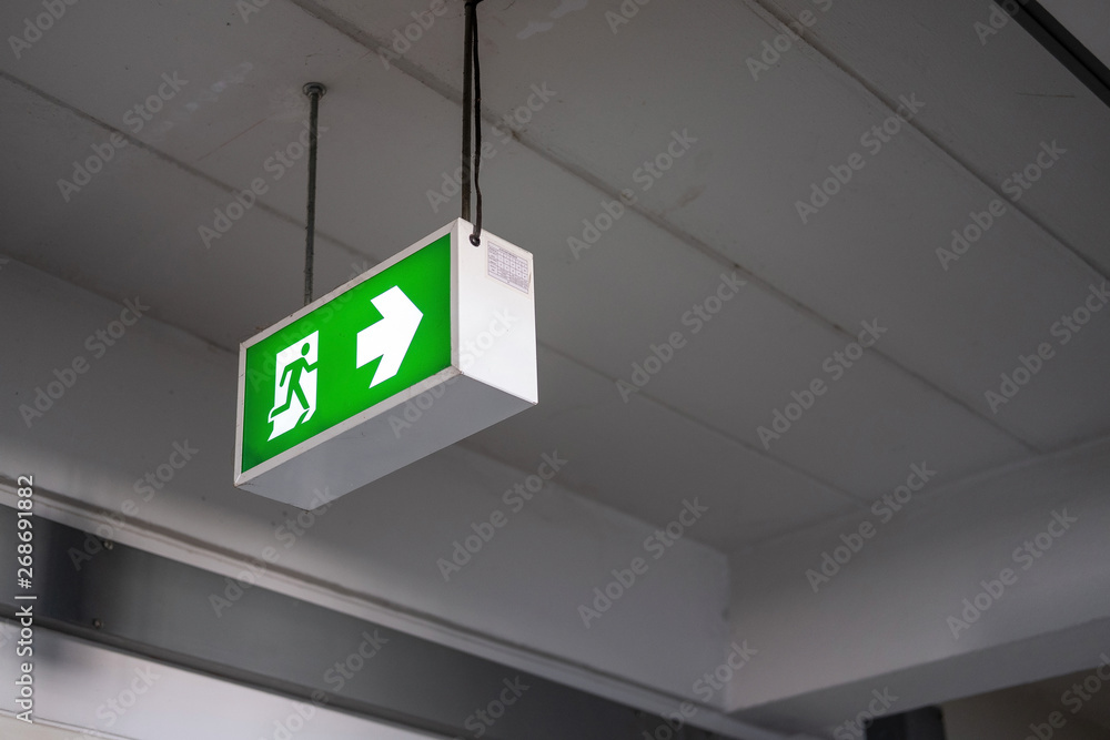 Emergency Fire exit sign at the corridor in building Emergency Fire exit sign at the corridor in building