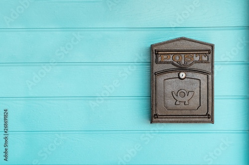 Canvas Print postbox hanging on a blue wood wall