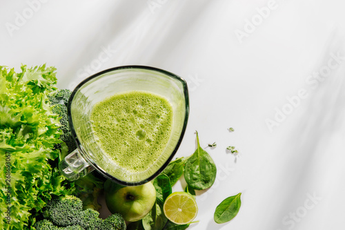 Healthy smoothies in a blender. Healthy food concept with spinach and green vegetables. Vegetarian food.