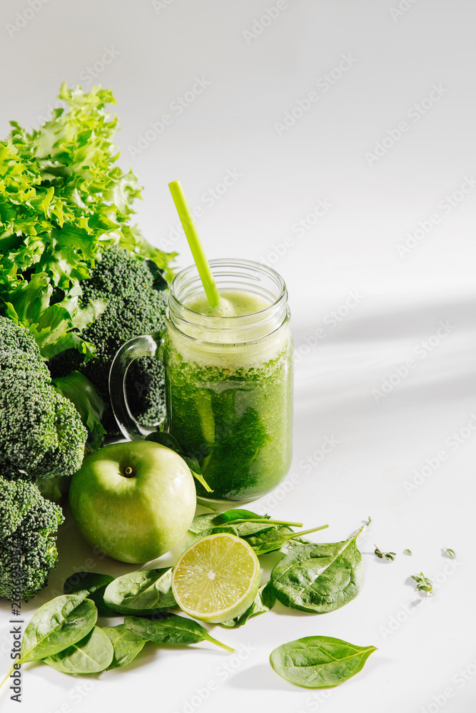 Healthy drink with spinach and green vegetables in jar on white background. Vegetarian food. Detox and diet concept. Healthy drink with spinach and green vegetables in jar on white background. Vegetarian food. Detox and diet concept.