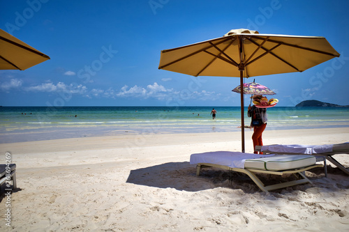 Seller bringing local fruits on beautiful Sao beach with white sand  Phu Quoc island  Vietnam