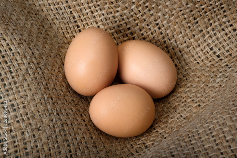 Beautiful crude eggs on burlap. Protein, protein, Top view. Beautiful crude eggs on burlap. Protein, protein, Top view.