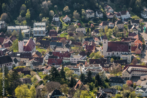 Little village in the middle of the german countryside with a church and half-timber houses and green trees
