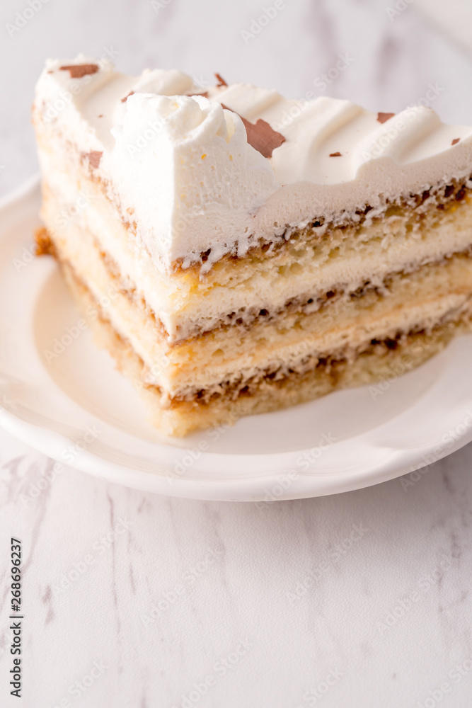 Tiramisu cake slice with white frosting Tiramisu cake slice with white frosting
