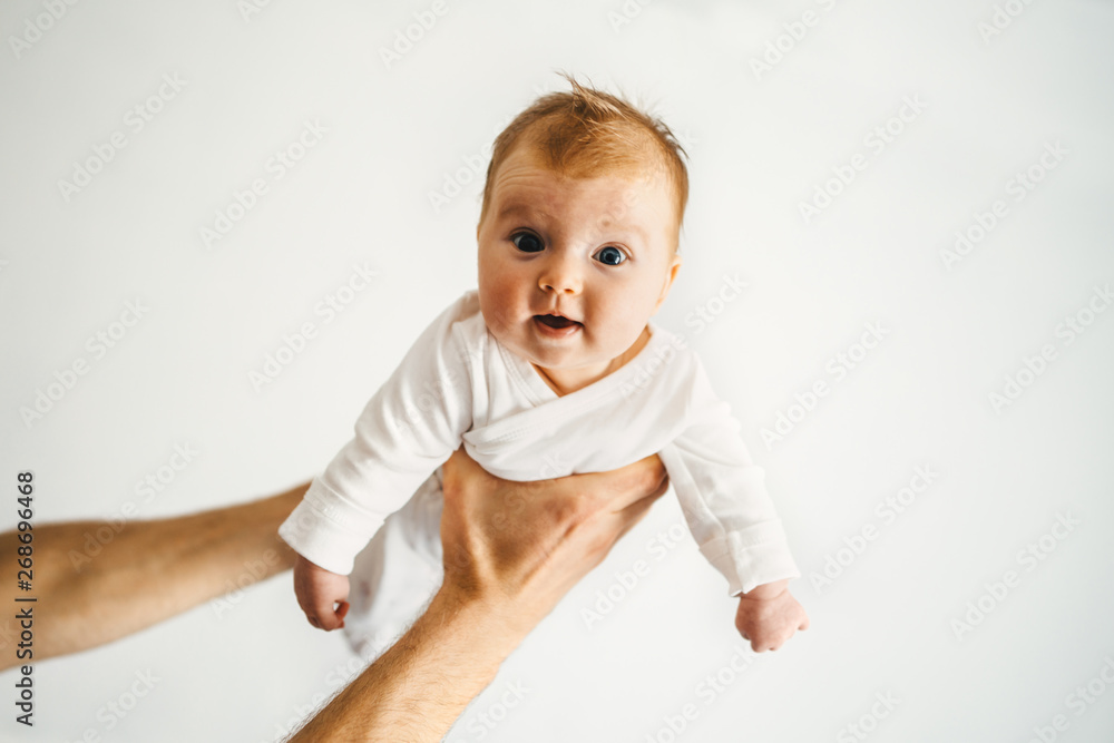 Father hands holding infant baby family lifestyle dad and child parenthood concept 3 month old kid - obrazy, fototapety, plakaty 