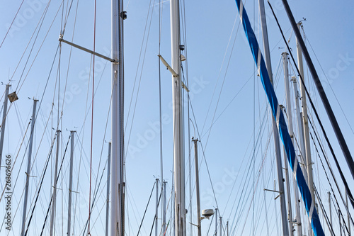 Sailing masts in the marina in a sunny da