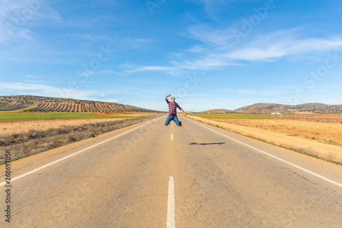 Happy successful man jumping in countryside road © william87