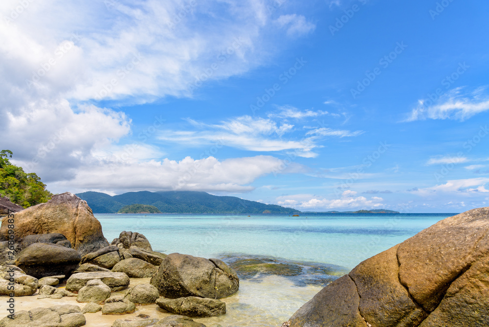 Beautiful tropics nature landscape of clear sea, beach, rocks and clouds on blue sky in the summer at Ko Ra Wi, See the Ko Adang in front near Koh Lipe island Tarutao National Park, Thailand - obrazy, fototapety, plakaty 