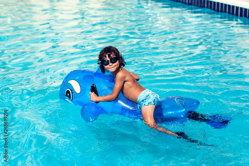 Little boy at the swimming pool. Children and summer concept