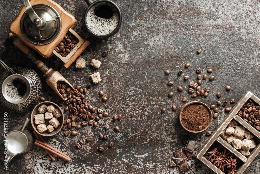 Coffee cup with coffee grinder and coffee beans on dark textured background. Coffee cup with coffee grinder and coffee beans on dark textured background.