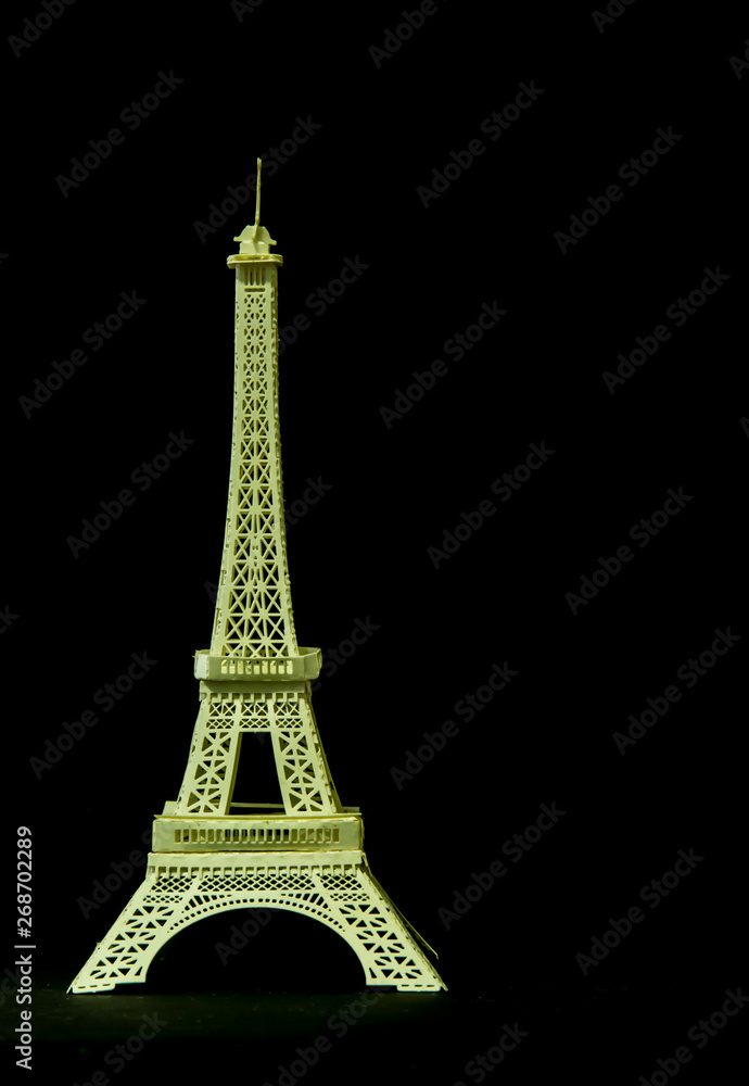 A model Eiffel tower of cardboard isolated on black