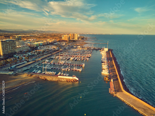 Aerial sunset view of the marina of La Pobla de Farnals, Valencia, Spain. Boats moored in the harbor at sunset of the Mediterranean photo