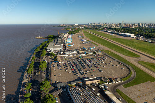 Aerial image showing the full Aeroparque Internacional Ing. Jorge Alejandro Newbery at the river Rio de la Plata with the city of Buenos Aires in the background.