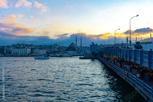 Fishermen are on the Galata Bridge, and people walk on the Galata bridge in summer, Istanbul, Turkey, 12.01.2019 © Yakup